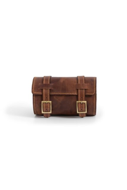 Brown Leather cylinder shoulder bag with buckle closure by Jirakis Leather.