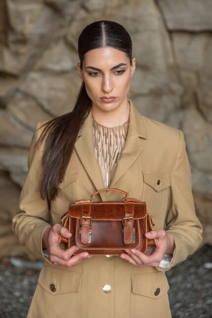 women holding brown Handcrafted leather satchel with multiple pockets and sturdy buckle straps – Jirakis Leather